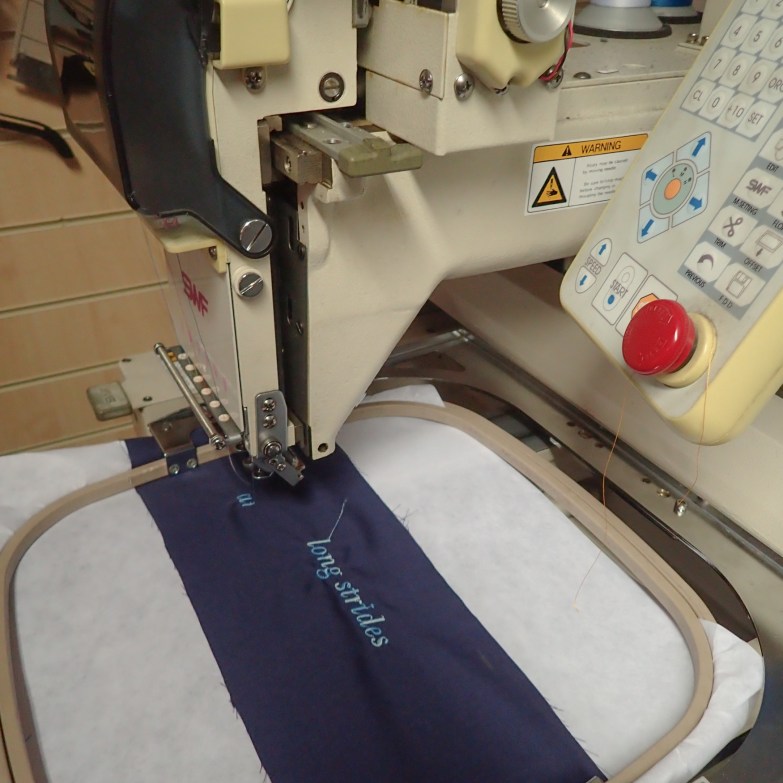 Stitching the poem on the indigo cloth