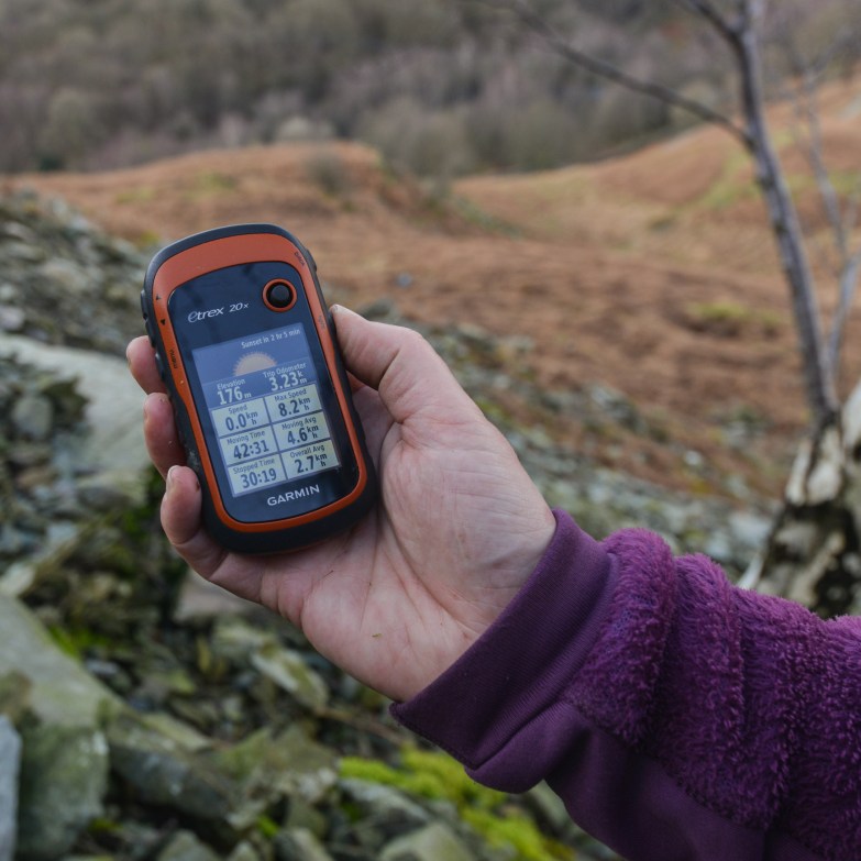 Holding the GPS at the sixth poem stone location.